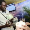 Rudolph Brown/ Photographer<\n>Anthony Henry of Solar Buzz Jamaica show a solar light to Caman Ellis at the JEA JMA Expo Jamaica at the National Indoor Sports Centre and the National Arena on Sunday April 22, 2018<\n><\n>