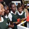 Rudolph Brown/ Photographer<\n>Erica Simmons, Executive Director of Caribbean Maritime University show students of Vere Tech how 3D Digital printer works at the JEA JMA Expo Jamaica at the National Indoor Sports Centre and the National Arena on Friday April 20, 2018<\n><\n>