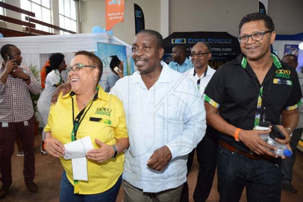 Rudolph Brown/ Photographer
Doreen Frankson, left, former President of the Jamaica Manufacturers Association (JMA) and Richard Pandolie, Deputy President of JMA give Robert Montague, (centre) Minister of Transport a tour of the JEA JMA Expo Jamaica at the National Indoor Sports Centre and the National Arena on Friday April 20, 2018