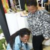 Rudolph Brown/ Photographer
Damion Crawford fit slippers on Sharon Burke foot at the JEA JMA Expo Jamaica at the National Indoor Sports Centre and the National Arena on Friday April 20, 2018
