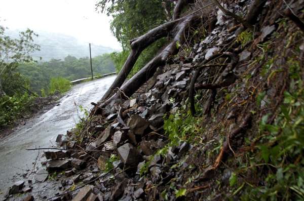 Ricardo Makyn/Staff Photographer.
Rocks from a Landslide that blocked a section of the Trinity Ville main road on Tuesday due to the Rain Fall.