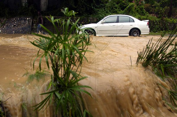 Ricardo Makyn/Staff Photographer.
 Motorist  drives  through the heavy Water  at the 11 Miles Bull Bay Fording on Tuesday 28.9.2010.