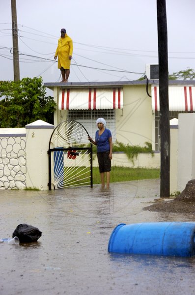 Norman Grindley/Chief Photographer
Flood waters threaten the home of Harbour View residents yesterday afternoon.