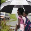 Norman Grindley/Chief Photographer
This woman piggy back a little girl from school in Harbour view in East Kingston during the heavy rain yesterday.