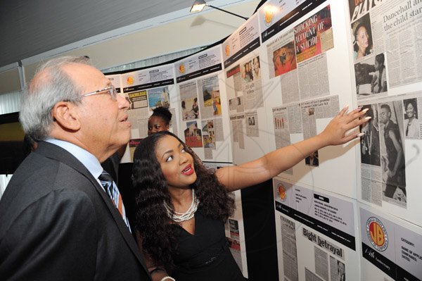 Rudolph Brown/ Photographer
Robert Levy, Chairman of Jamaica Broilers Group and Sadeke Brooks looks at the display at the Fair Play award of excellence 2013/2014 held at the Terra Nova Hotel, Kingston on September 16, 2014