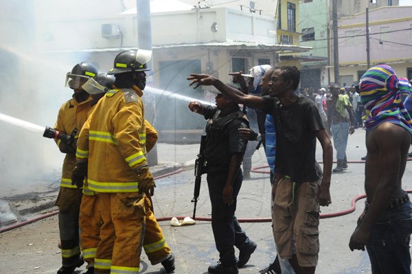 Norman Grindley/Chief Photographer
A major fire this afternoon destroyed several houses on Regent Street in downtown Kingston. Three fire units and a water truck arrived on the scene as fire personnel tried to contain the blaze September 26, 2012.