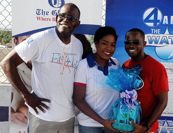 Lionel Rookwood/PhotographerThe Gleaner's Fit 4 Life Sweatfest at the Life Fit Training Centre, 15 3/4 Red Hills Road, St Andrew, with aerobics instructor O.J. O'Gilvie on Saturday, November 18, 2017. *** Local Caption *** Lionel Rookwood/PhotographerAhon Gray (right) wins a gift basket from Chas E. Ramson brand manager, Sherida Cohen. Sharing in the moment is Rainford Wint, Gleaner sales manager.