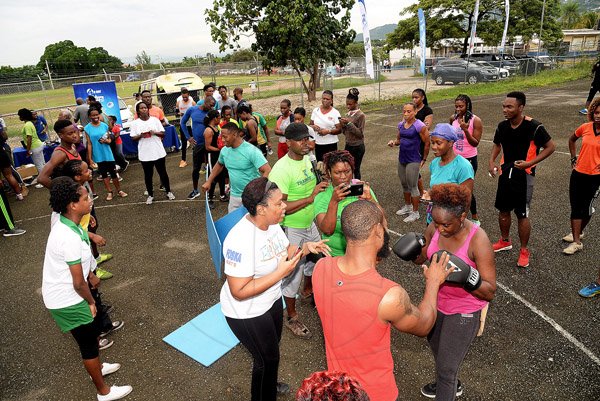 Lionel Rookwood/PhotographerThe Gleaner's Fit 4 Life event with the Trainfit Club's Outdoor Madness, Boxing Fitness with Sakima Mullings and Self Defense with Master Arthur Barrows on Saturday, November 11, at In Motion Gym, Shortwood Teachers' College, St Andrew. *** Local Caption *** Lionel Rookwood/PhotographerContender champion Sakima Mullings giving boxing lessons.