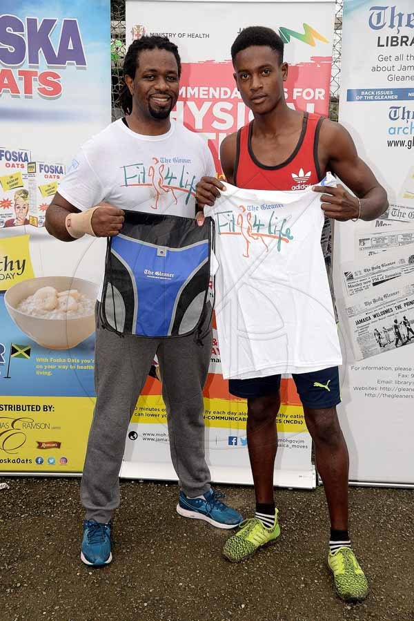 Lionel Rookwood/PhotographerThe Gleaner's Fit 4 Life event with the Trainfit Club's Outdoor Madness, Boxing Fitness with Sakima Mullings and Self Defense with Master Arthur Barrows on Saturday, November 11, at In Motion Gym, Shortwood Teachers' College, St Andrew. *** Local Caption *** Lionel Rookwood/PhotographerWinner of the legs, thighs and core challenge, Rajae Morgan (right), getting his prizes from Marvin Gordon from The Gleaner's Fit 4 Life.