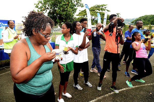 Lionel Rookwood/PhotographerThe Gleaner's Fit 4 Life event with the Trainfit Club's Outdoor Madness, Boxing Fitness with Sakima Mullings and Self Defense with Master Arthur Barrows on Saturday, November 11, at In Motion Gym, Shortwood Teachers' College, St Andrew. *** Local Caption *** Lionel Rookwood/PhotographerEnjoying hot, delicious bowls of sponsor Foska Oats’ new line of instance porridge, available in various flavours, as well as packets of Blue Diamond Almond, another sponsor. Refreshing bottles of WATA also kept everyone going.