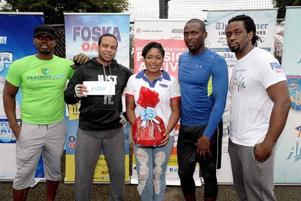 Lionel Rookwood/PhotographerThe Gleaner's Fit 4 Life event with the Trainfit Club's Outdoor Madness, Boxing Fitness with Sakima Mullings and Self Defense with Master Arthur Barrows on Saturday, November 11, at In Motion Gym, Shortwood Teachers' College, St Andrew. *** Local Caption *** Lionel Rookwood/PhotographerWinners of the tyre challenge Bruce Williams (second left) and Gavin Francis (second right) getting their prizes from Stokely Rose (left) from TrainFit Club; Sherida Cohen (centre), brand manager of Chas E. Ramson - Foska Oats & Blue Diamond Almond Milk and The Gleaner's Fit 4 Life fitness coach, Marvin Gordon.