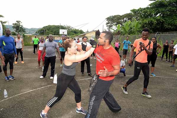 Lionel Rookwood/PhotographerThe Gleaner's Fit 4 Life event with the Trainfit Club's Outdoor Madness, Boxing Fitness with Sakima Mullings and Self Defense with Master Arthur Barrows on Saturday, November 11, at In Motion Gym, Shortwood Teachers' College, St Andrew. *** Local Caption *** Lionel Rookwood/PhotographerMaster Arthur Barrows, president of the Jamaica Taekwon-Do Association, taking The Gleaner's Fit 4 Life participants through a series of self defense lessons.
