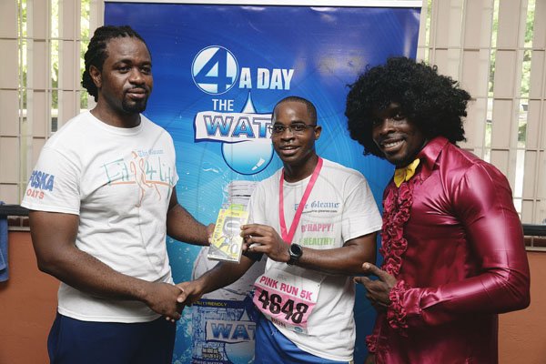 Lionel Rookwood/PhotographerThe Gleaner's Fit 4 Life event with Body By Kurt - FitMix - 3-The-Hard-Way - at 23 Haining Road, New Kingston on Saturday, October 28, 2017.  *** Local Caption *** Lionel Rookwood/PhotographerAhon Gray (centre), winner of the Burpees Challenge, collecting his Active band from Asafa Powell from The Gleaner's Fit 4 Life fitness coach, Marvin Gordon (left) and fitness coach, Kurt Dunn from Body By Kurt.