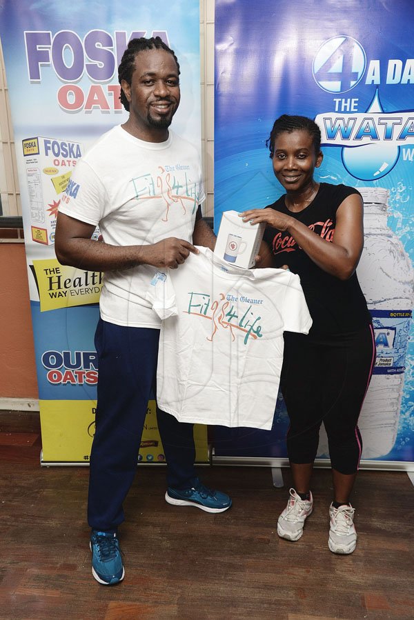 Lionel Rookwood/PhotographerThe Gleaner's Fit 4 Life event with Body By Kurt - FitMix - 3-The-Hard-Way - at 23 Haining Road, New Kingston on Saturday, October 28, 2017.  *** Local Caption *** Lionel Rookwood/PhotographerSecond place winner Arlette Robinson in the Wata Challenge, receiving her prizes from The Gleaner's Fit 4 Life fitness coach, Marvin Gordon.