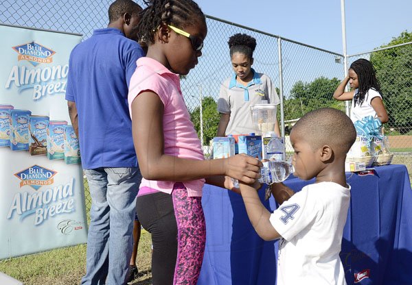 Ian Allen/PhotographerThe Gleaner's Fit 4 Life team at Hope Pastures Park, Hope Pastures, St Andrew on Saturday, October 14, 2017. *** Local Caption *** Ian Allen/PhotographerThis youngster was quenching his thirst courtesy of The Gleaner's Fit 4 Life sponsor, Wata.