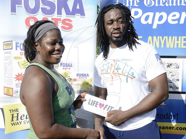 Ian Allen/PhotographerThe Gleaner's Fit 4 Life team at Hope Pastures Park, Hope Pastures, St Andrew on Saturday, October 14, 2017. *** Local Caption *** Ian Allen/PhotographerCheryl Wright (second right), president of the Hope Pastures Citizens Association, accepts her Life Fit membership from The Gleaner's Fit 4 Life fitness coach Marvin Gordon.