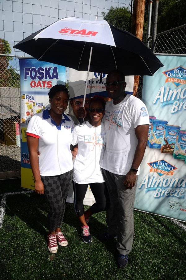 Lionel Rookwood/Photographer

The Gleaner's Rainford Wint with Dionne DaCosta-Sicard (centre), winner of the women's jump squats challenge, and Sherida Cohen, brand manager of Foska and Blue Diamond at The Gleaner's Fit 4 Life and St Matthew's Walkers event on Saturday, October 7, 2017 at the Jacks Hill Community Centre in St Andrew.