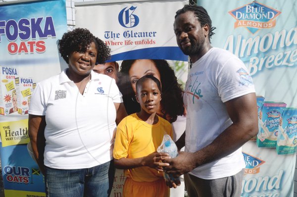 Lionel Rookwood/Photographer

The Gleaner's Terry-Ann Wilson and Marvin Gordon (right) withTyrese Small, winner of the weights challenge for men at The Gleaner's Fit 4 Life and St Matthew's Walkers event on Saturday, October 7, 2017 at the Jacks Hill Community Centre in St Andrew.