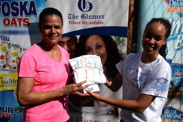 Lionel Rookwood/Photographer

Tracey Neil (left), winner of the women's plank challenge, receives her prize from The Gleaner's Amashika Lorne (second right) at The Gleaner's Fit 4 Life and St Matthew's Walkers event on Saturday, October 7, 2017 at the Jacks Hill Community Centre in St Andrew.