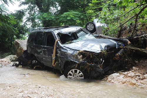 Ian Allen/Photographer
Two motor vehicles in the Mannings Hill gully after they wash over the gully during heavy rains associated with Tropical Storm Nicole on Wednesday night.