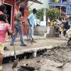Gladstone Taylor / Photographer

Members from the nearby community clear the block drained of rocks, mud and other debris on Barbican Avenue