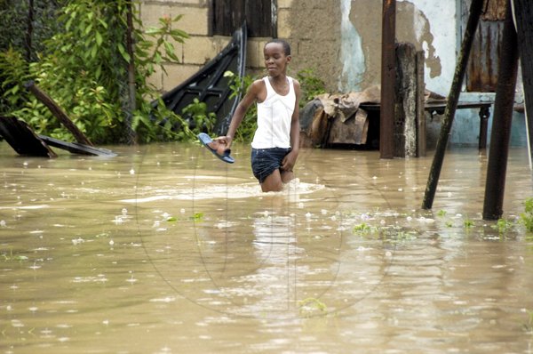 Ricardo Makyn/Staff Photographer.
 A child wades through a flooded yard







Walks Road  in Spanish Town that was flooded  on Wednesday 29.9.2010.