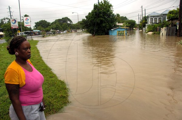 Ricardo Makyn/Staff Photographer.
This Lady look's on as a section of Walks Road adjacent to the McKoy Gardens  community is Flooded in Spanish Town on Wednesday 29.9.2010.
