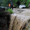 Rudolph Brown/Photographer
Workmen clear landslides on Castleton main road after block by heavy rain fall in St. Mary on Wednesday, September 29-2010