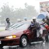Rudolph Brown/Photographer
These young men push this motor vehicle through the rain on Marescaux Road near Heroes Circle, Kingston, yesterday.
