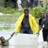 Ricardo Makyn/Staff Photographer.
 These Youngster's enjoy a ride in this Fridge  on Walks Road   in Spanish Town that was flooded  on Wednesday 29.9.2010.