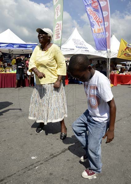 Gladstone Taylor / Photographer

Keveun Hewitt (left) accepts his prize from Julette Hosang (Brand Manager, Sir Henry)  for the newspaper dance competition as seen at the shoppers fair food month promotion in Harbour View on saturday