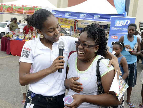 Gladstone Taylor / Photographer

Terry-Karelle Reid acknoledges Rosemarie Liang (right) as the winner of the maggie slogan contest  as seen at the Gleaner company food moth promotion held at shoppers fair super market on brunswick avenue, spanish town on saturday