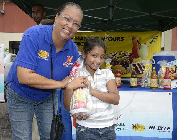 Gladstone Taylor / Photographer

Akira Guyah (right) is presented with a gift basket by Julette Hosang (Brand Manager, Sir Henry) as a prize for the Newspaper dance competition as seen at the Gleaner company food moth promotion held at shoppers fair super market on brunswick avenue, spanish town on saturday