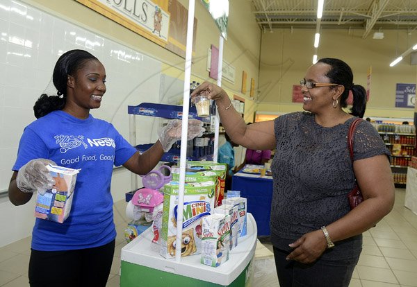 Gladstone Taylor / Photographer

Charmaine Roberts tries one of the cereal's from nestle representative Dorraine Thomas as seen at the Gleaner company food moth promotion held at shoppers fair super market on brunswick avenue, spanish town on saturday