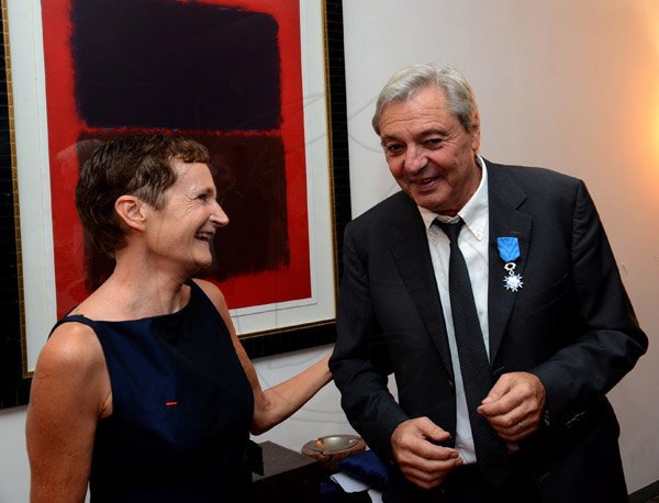 Winston Sill/Freelance Photographer
French Ambassador Ginette de Matha host Reception and Handing over of the  insignia of French National Order of Merit to Etienne Andre`, held at Hillcrest Avenue on Friday night March 14, 2014. Here are Ambassador de Matha (left); and Etienne Andre` (right) with his medel on.