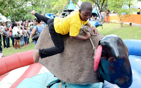 Rudolph Brown/Photographer
This Youngster had a Bull of a time has he was caught in camera riding the Mechanical Bull  At Funfest 2014 a family festival   held at  Hope Garden's  on Sunday, December 21, 2014