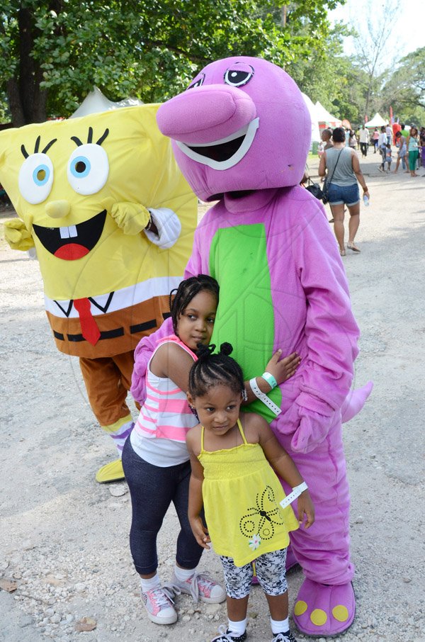 Rudolph Brown/Photographer

Two children enjoy the company of a mascot during  Funfest at Hope Garden, St Andrew, recently on Sunday, December 21, 2014