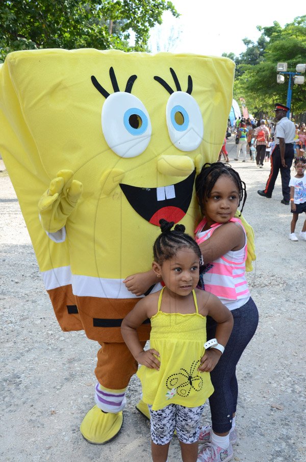 Rudolph Brown/Photographer
Children having fun with sponge Bob the
mascot at Funfest at Hope Garden on Sunday, December 21, 2014
