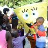 Rudolph Brown/Photographer
Children having fun with sponge Bob the
mascot at Funfest at Hope Garden on Sunday, December 21, 2014