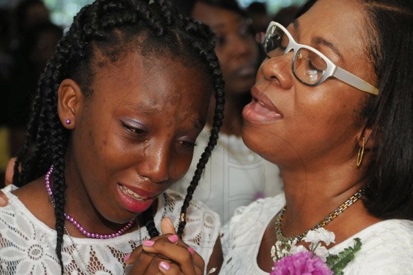 Jermaine Barnaby/Freelance PhotographerCollette Spaulding (right) sister comforts Kendra Spaulding at the thanksgiving service honouring God in celebrating the life of her father, Gary Spaulding at the Portmore Gospel Assembly in Portmore Drive in Portmore on Saturday July 2, 2016.