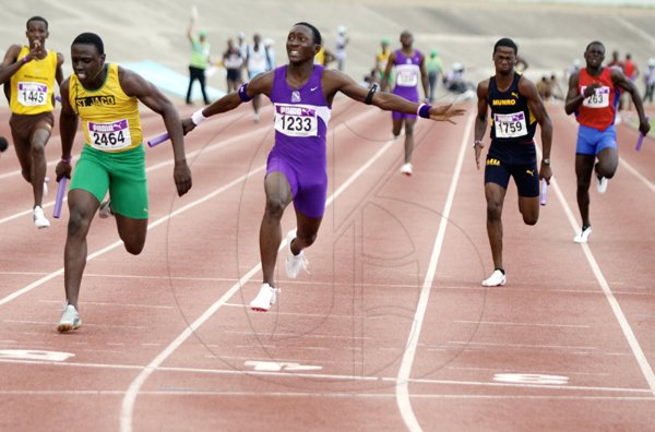 Anthony Minott/Freelance Photographer
Keneil Grant (second left), of Kingston College anchors his team to victory over a St Jago athlete in the boys class two 4x00m event, during the 34th staging of the Gibson Relays at the National Stadium on Saturday, February 27, 2010.