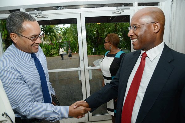 Rudolph Brown/Photographer
Christopher Barnes Managing Director of the Gleaner Company greets AubynHill, (right) CEO of Corporate Strategies Limited at the Gleaner sales awards ceremony at the Terra Nova Hotel in Kingston on Monday, January 20, 2014
