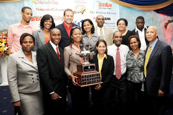Rudolph Brown/Photographer
Oral McCook (left, front row) of OGM Communications shares the spotlight with staff and clients as the company took its second straight Top Billers Award at the Gleaner's Advertisers and Agency awards luncheon at the Jamaica Pegasus Hotel in New Kingston on Monday, February 22-2010