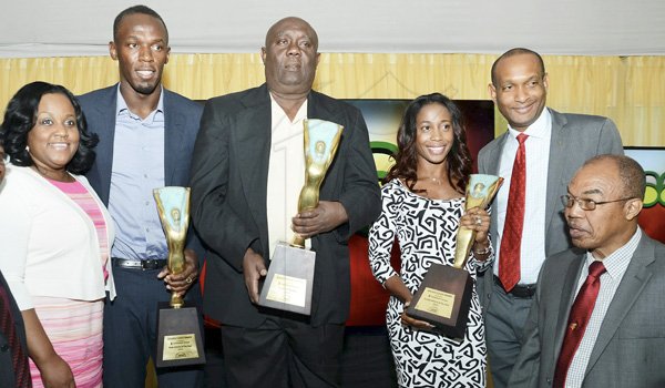 Rudolph Brown/Photographer
Dr. Warren Blake, (right) President of JAAA, Lissant Mitchell, (second right) CEO Scotia Investments and Natalie Neita-Headley, (left) Minister of State in the Ministry of Sports pose with Glen Mills, (centre) Coach of the Year and Olympians Usain Bolt, Male athlete of the year and Female Athlete of the year Shelly-Ann Fraser Pryce at the Scotiabank Golden Cleats Awards Luncheon at Venetian Suite, Terra Nova Hotel on Tuesday, January 8, 2013.