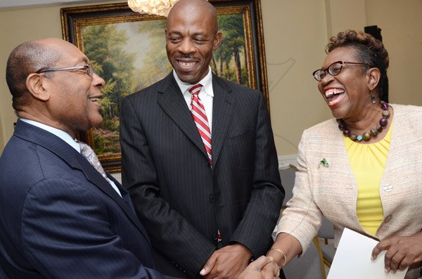 Rudolph Brown/Photographer
Police Commissioner Dr Carl Williams, (second left) chat with Dr. Henry Lowe, (left) and  DPP Paula Llewellyn at the Governor General’s Achievement Award for the County of Surrey presentation Ceremony for recipients on Thursday, September 25, 2014