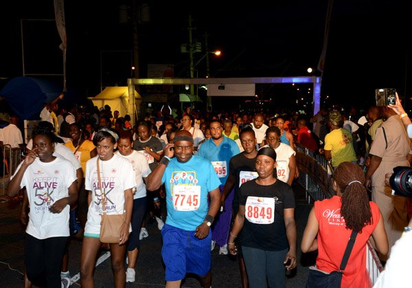 Winston Sill/Freelance Photographer
Guardian Group,  Keep It Alive 5K Night Run, held in New Kingston on Saturday night June 21, 2014. Here the walkers are off.