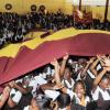 Norman Grindley /Chief Photographer
A massive banner bearing the school colours is brought out by Holmwood students during the celebration to mark their eight victory at the ISSA/GraceKennedy Boys' and Girls' Championships inside the school's auditorium yesterday.
