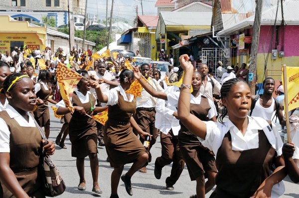Norman Grindley /Chief Photographer
Students of Holmwood Technical High School march the streets of Christiana, Manchester yesterday as they celebrate their victory in the 2010 Girls's Athletics Championships.