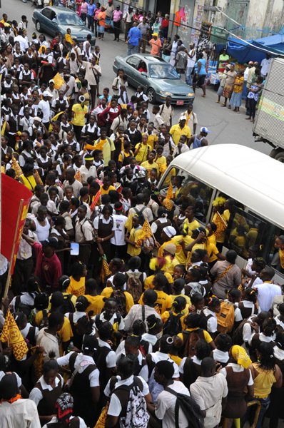 Norman Grindley /Chief Photographer
Holmwood athletes and students march along the streets of Christiana, Manchester in celebration of their eight triumph at the ISSA/GraceKennedy Boys' and Girls' Championships which ended at the National Stadium last Saturday.
