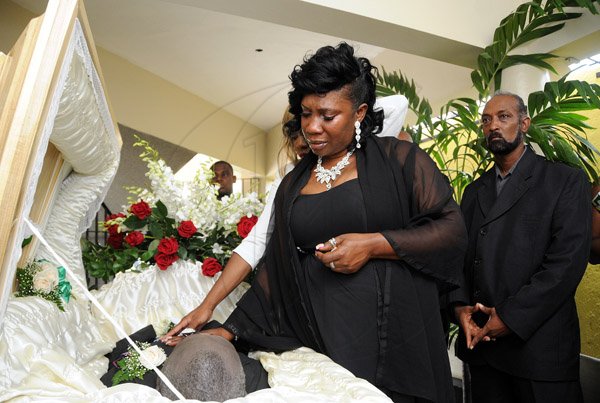 Gladstone Taylor / Photographer

daughters Kimberly Hibbert(left) and Angela Hibbert-Wright say their final goodbyes. Newphew Desmond Jadusingh looks on

Service of thanksgiving for the life of Joseph Hibbert held at the pentecostal gospel temple, kingston